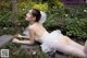 A woman in a wedding dress laying on the ground.