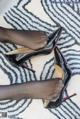 A pair of black high heels on a zebra print rug.