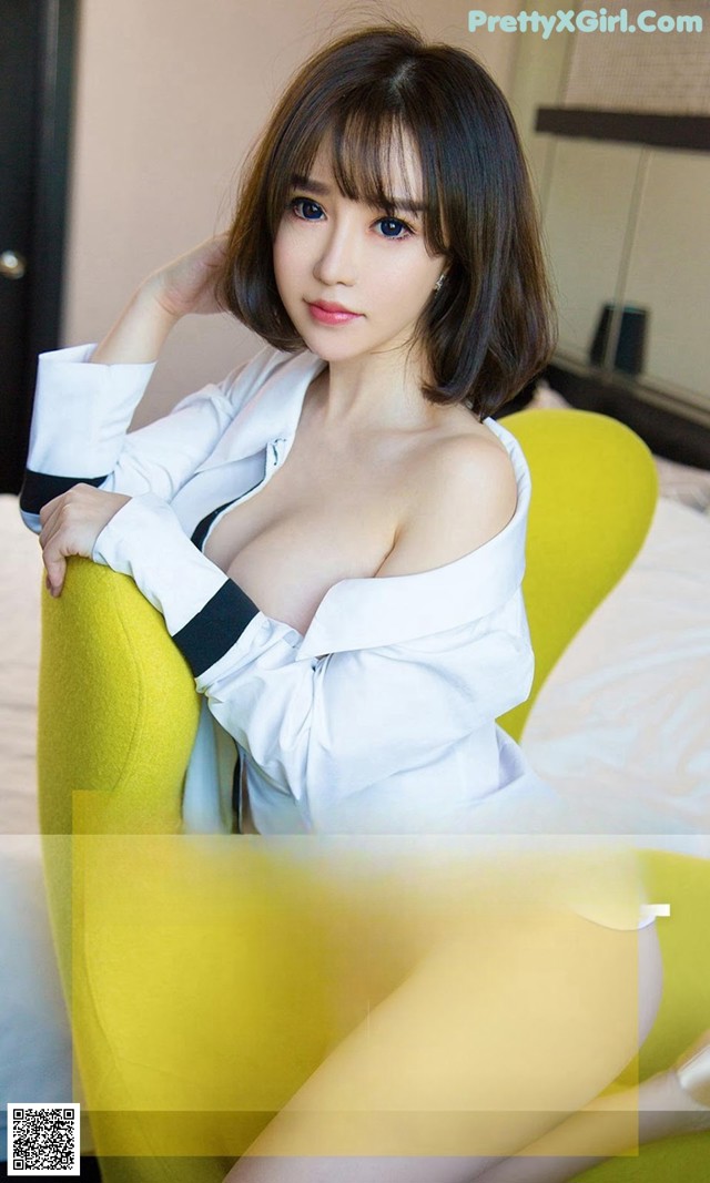 a woman sitting on top of a yellow chair